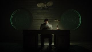 Alan Wake 2 gameplay screenshot showing Alan in a dark forest