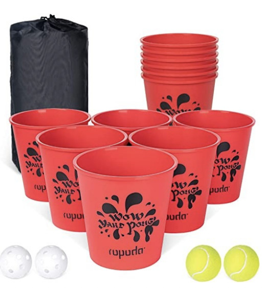 A set of red cups and white and yellow ping-pong balls for outdoor family gaming. 