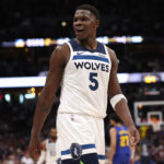Anthony Edwards smiling on the court, celebrating a Timberwolves victory, showcasing his impact on the team's success