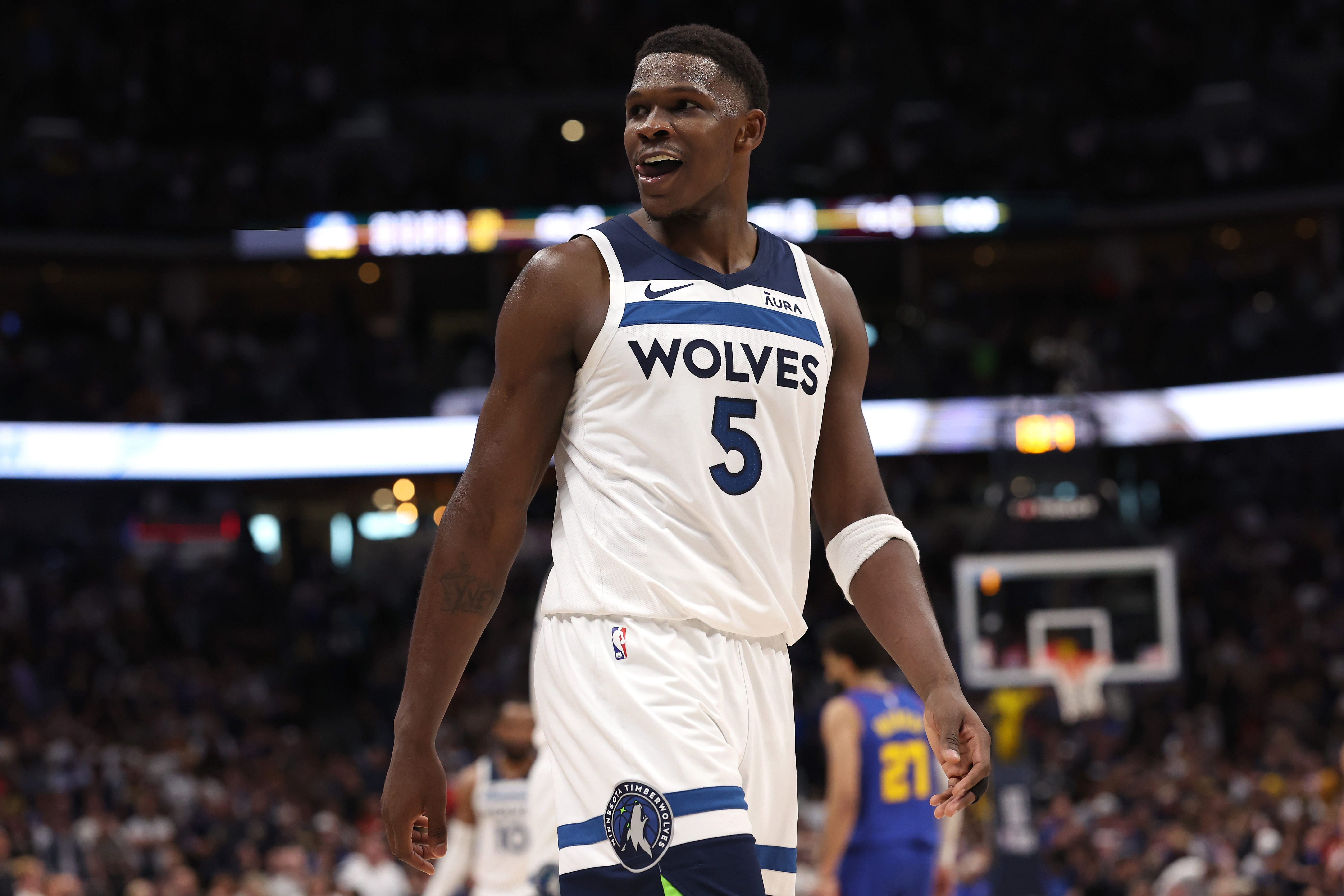 Anthony Edwards smiling on the court, celebrating a Timberwolves victory, showcasing his impact on the team's success
