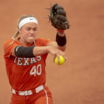 Tennessee softball players celebrate after defeating UCLA in the WCWS elimination game