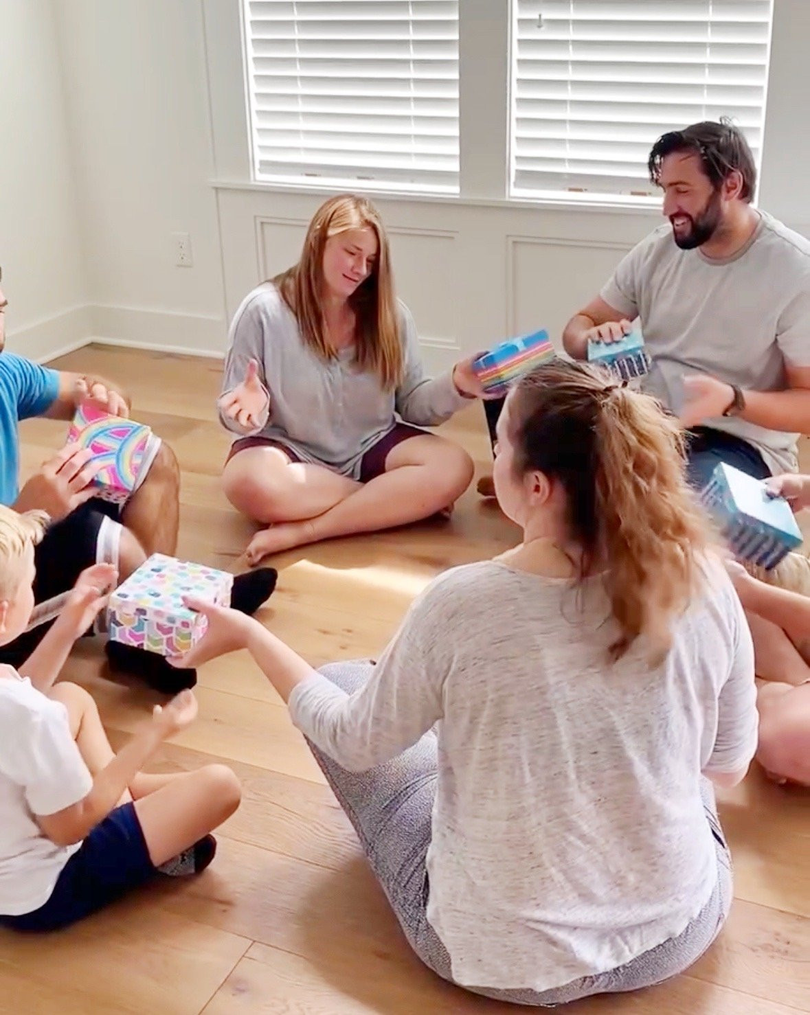 People sitting in a circle passing gifts around