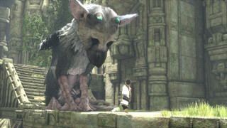 A young boy looking at Trico in a ruin during The Last Guardian.