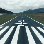 A detailed image showing a paper airplane runway setup, emphasizing the various scoring zones and artistic details