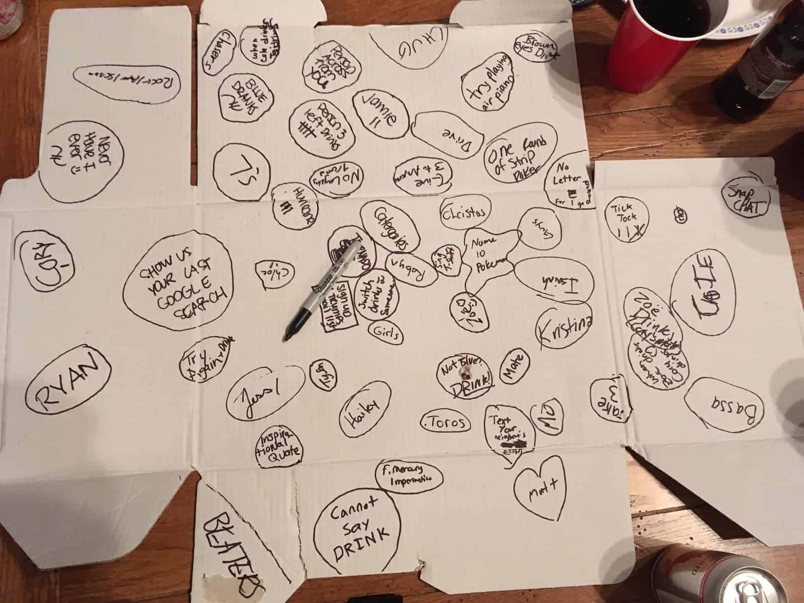 Pizza box with various drinking game dares written on it