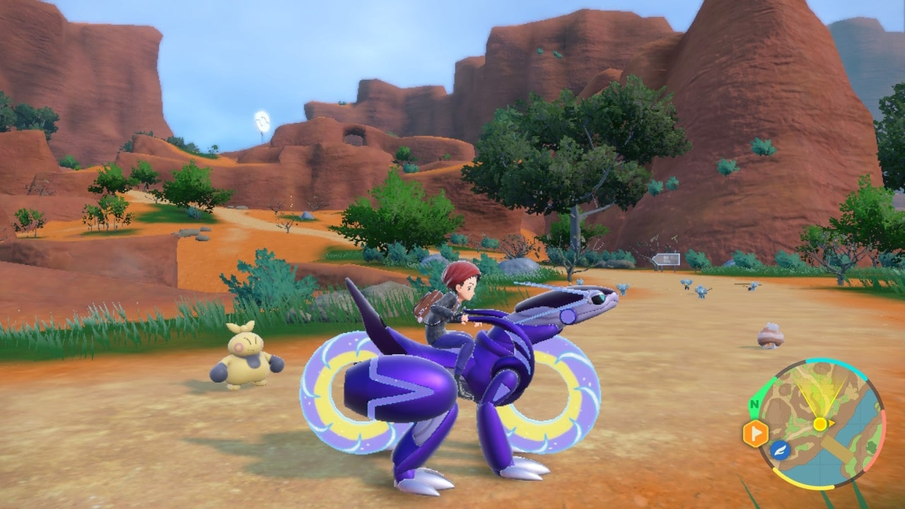 The Pokémon trainer rides a Miraidon in the open world of Pokémon Scarlet Scarlet and Violet. It shows open-world exploration aboard a legendary Pokémon in the latest game.