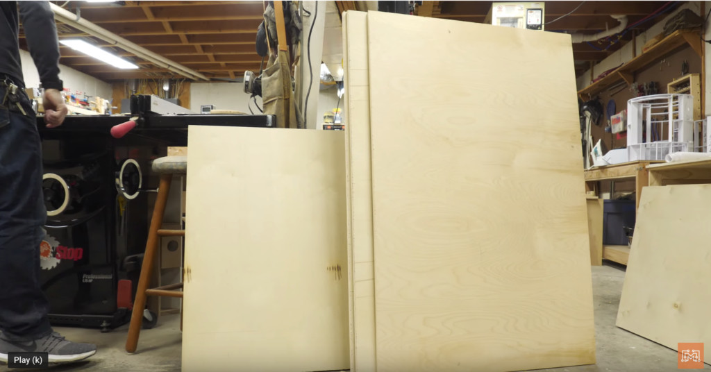Assembling the base section of a Mortal Kombat arcade cabinet with a coin slot