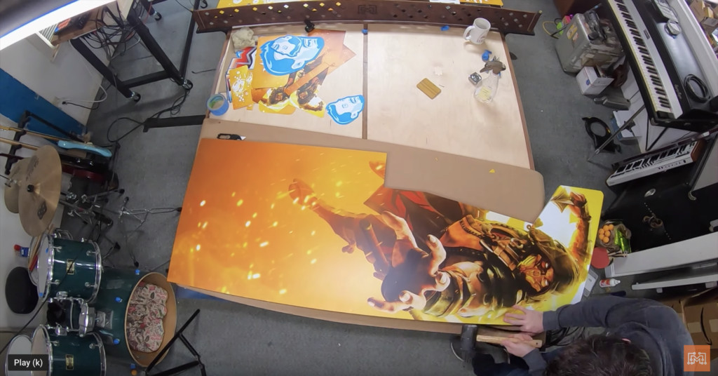 Applying vinyl graphics to the Mortal Kombat arcade cabinet