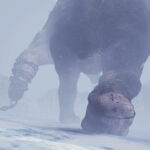 A skycraper-sized behemoth strides away from the player, dragging a gigantic iron ball on a chain behind it. The behemoth is dragging a gigantic iron ball