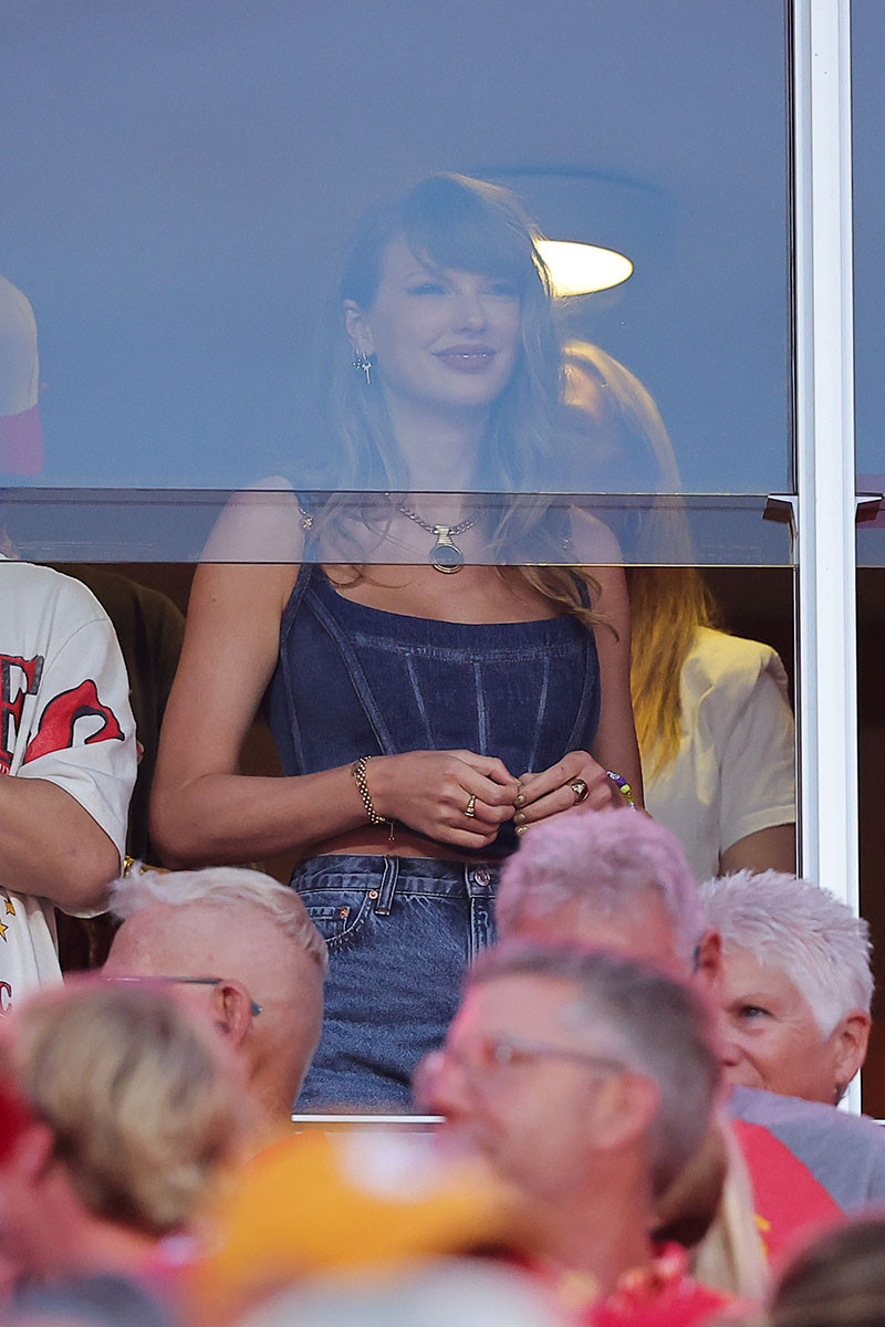 KANSAS CITY, MISSOURI - SEPTEMBER 05: Taylor Swift watches as the Kansas City Chiefs take on the Baltimore Ravens during the first quarter at GEHA Field at Arrowhead Stadium on September 05, 2024 in Kansas City, Missouri. (Photo by David Eulitt/Getty Images), lwymmd boots, guiseppe zanotti red boots, versace denim medusa 95 bustier corset top