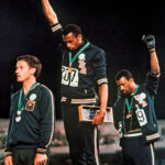 Tommie Smith and John Carlos Raising Black-Gloved Fists During the 1968 Olympic Games