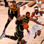 LeBron James driving against Jerami Grant in Lakers vs Nuggets game