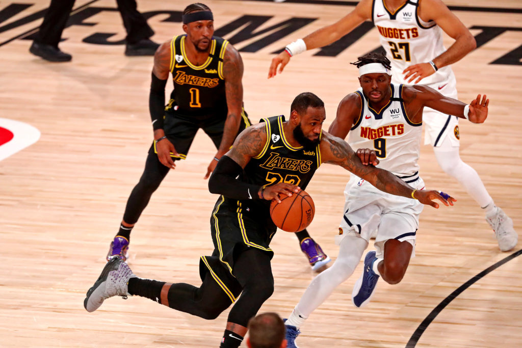 LeBron James driving against Jerami Grant in Lakers vs Nuggets game
