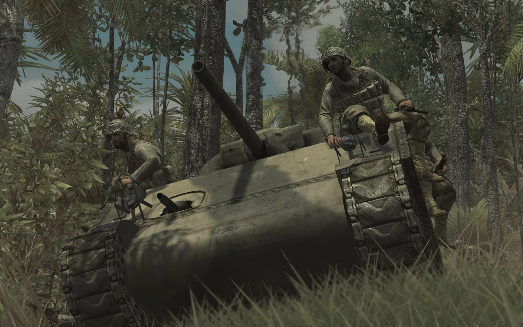 Soldiers sit on a rolling WW2 tank