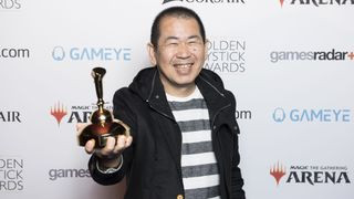 Yu Suzuki holds his Lifetime Achievement award in 2019